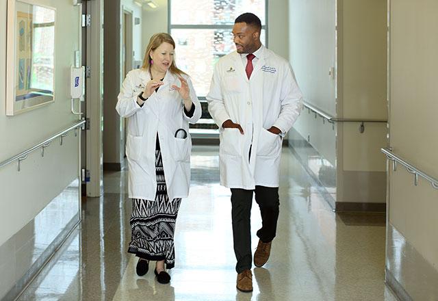 doctors walk and talk in hall