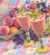 Colorful table setting with two peach melba smoothies